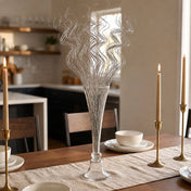 Silver sparkle curly ting stems in a glass vase on a dining table - thumbnail number 9