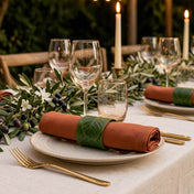 Banana leaf napkin ring holding a rust orange napkin on an outdoor table setting - thumbnail number 3