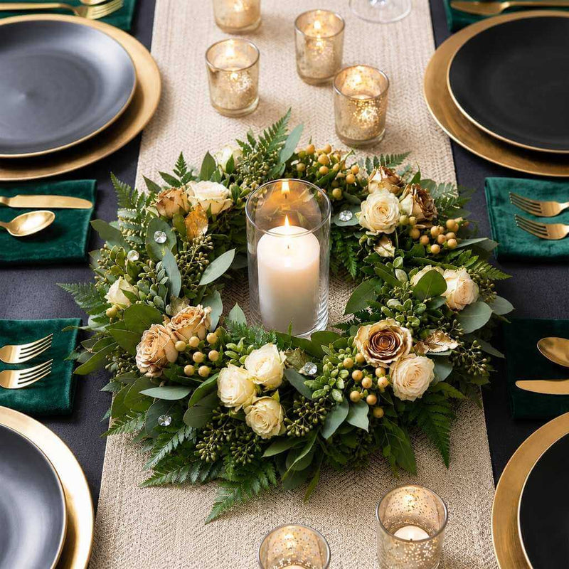 Green floral wreath centerpiece with a single pillar candle on a holiday table - thumbnail number 3
