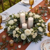 White rose and greenery wreath centerpiece with pillar candles on a rustic table - thumbnail number 5