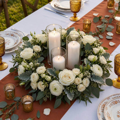 White rose and greenery wreath centerpiece with pillar candles on a rustic table - thumbnail number 5