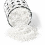 Natural white sand spilling from a glass holder - thumbnail number 1
