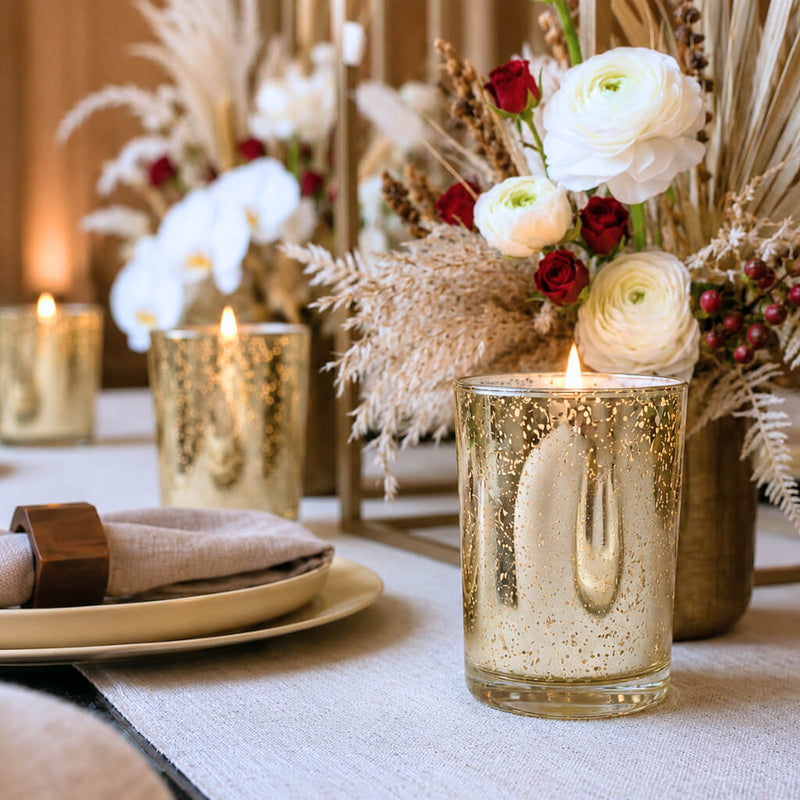 An elegant event tablescape featuring a lit candle inside a Metallic Gold Mercury Votive Holder - thumbnail number 5