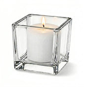 Lit white candle in clear square glass holder on white background - thumbnail number 3