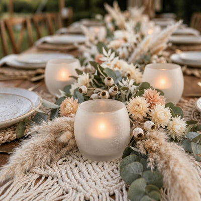 Frosted glass votives with pampas grass and florals on a macrame runner for a boho outdoor event - thumbnail number 4