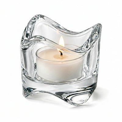 Clear glass candle holder with a lit white candle on a white background - thumbnail number 3