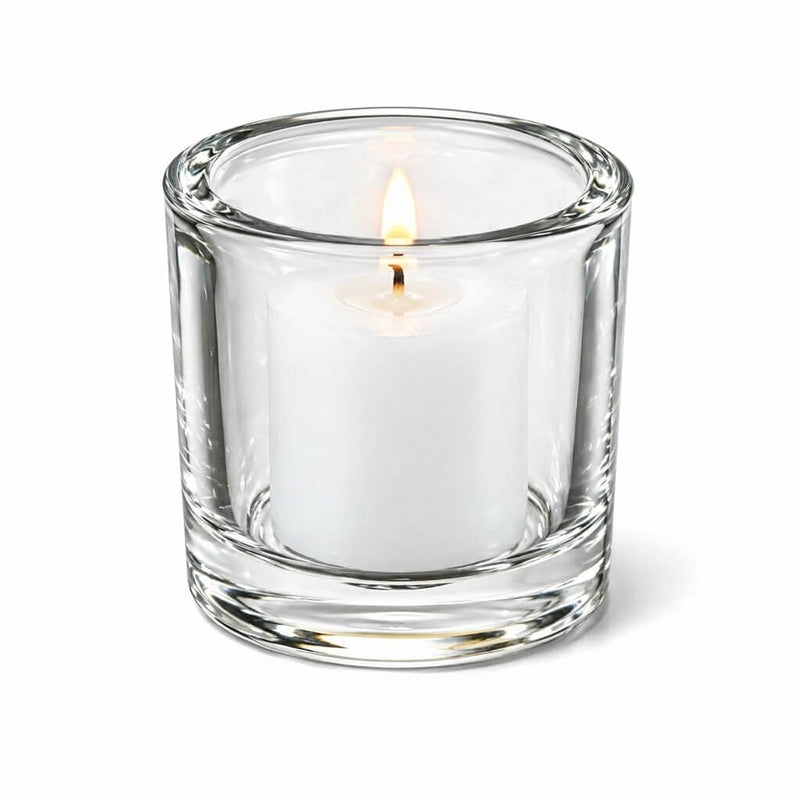 Lit white votive candle in clear glass holder on white background - thumbnail number 5