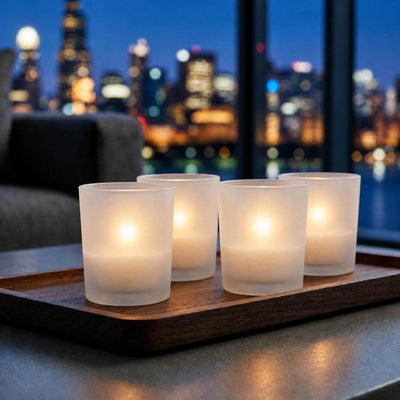 Four glowing frosted candle holders beside nighttime city view - thumbnail number 7