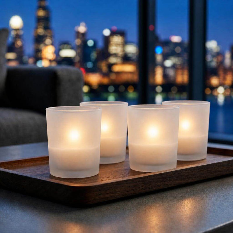 Four glowing frosted candle holders beside nighttime city view - thumbnail number 7