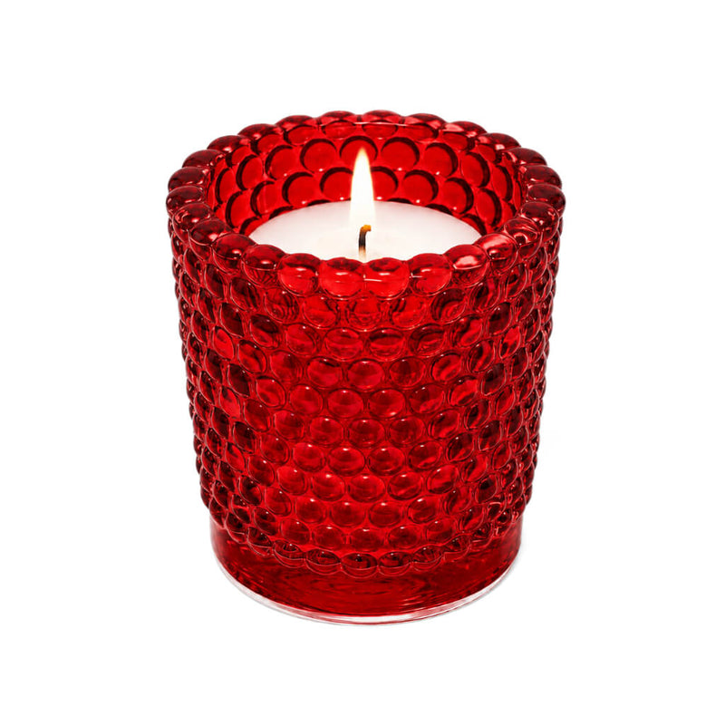 Red hobnail glass votive holder with glowing candle on white backdrop - thumbnail number 3
