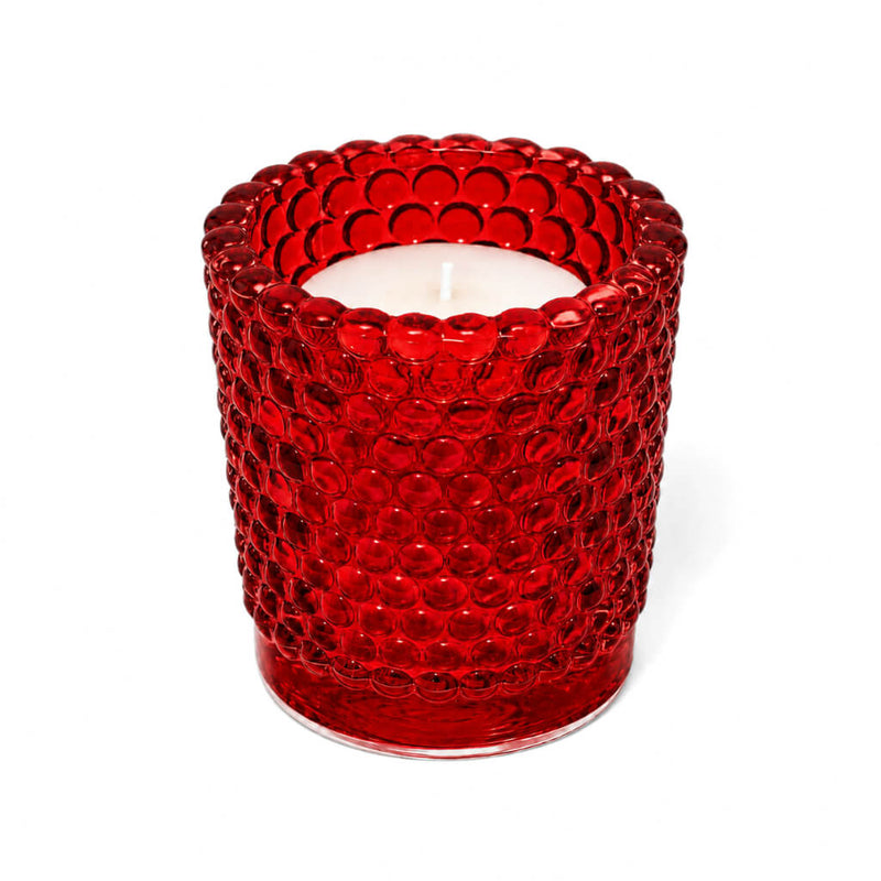 Red hobnail glass votive holder with white candle on white background - thumbnail number 2
