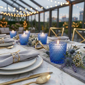 Blue hobnail votive holders with lit white candles on elegant outdoor dining table - thumbnail number 4