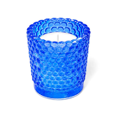 Blue hobnail glass votive candle holder with white candle on white background - thumbnail number 2