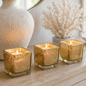 Metallic gold mercury square votive holders glowing on a wooden tabletop display - thumbnail number 7