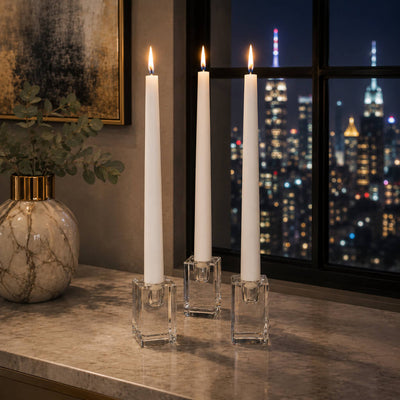 Lit white candles in clear glass candlesticks with city skyline view - thumbnail number 6