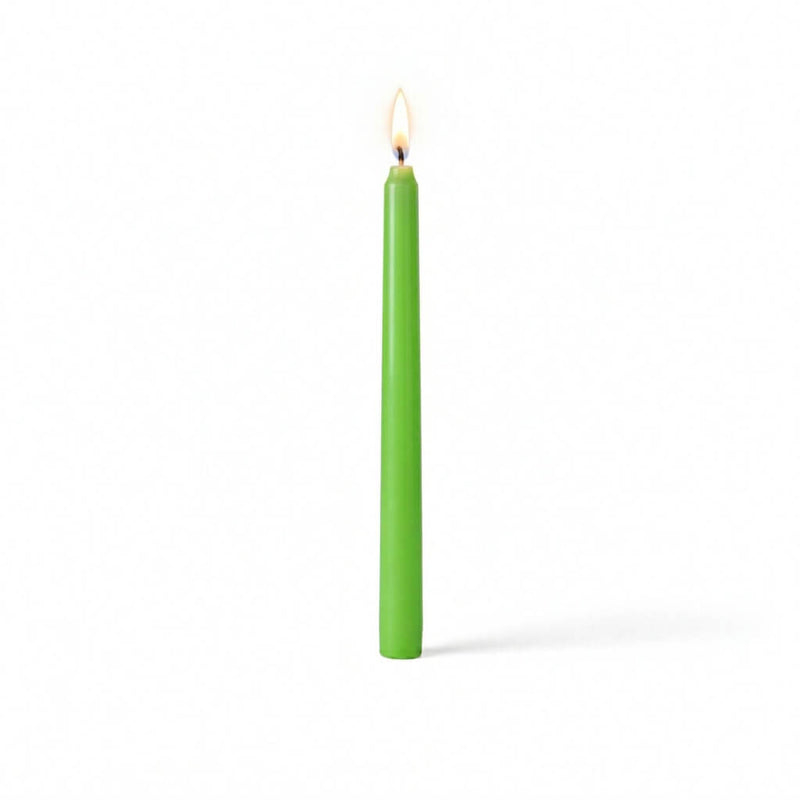 Single green taper candle with flame on white surface - thumbnail number 2