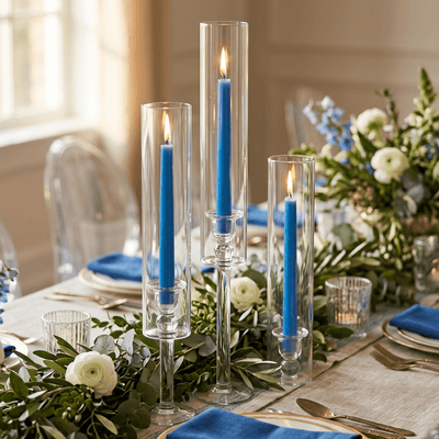 Elegant table setting with blue candles and white floral arrangements - thumbnail number 3