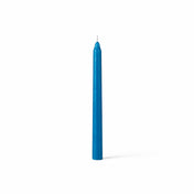 Unlit blue taper candle standing on white background - thumbnail number 1