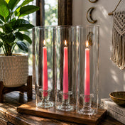 Lit pink taper candles inside tall glass candle holders - thumbnail number 6