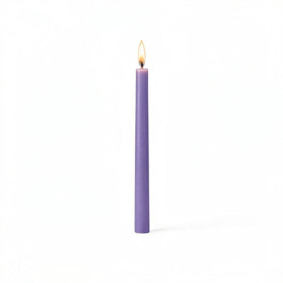 Single lavender taper candle glowing on white surface - thumbnail number 2