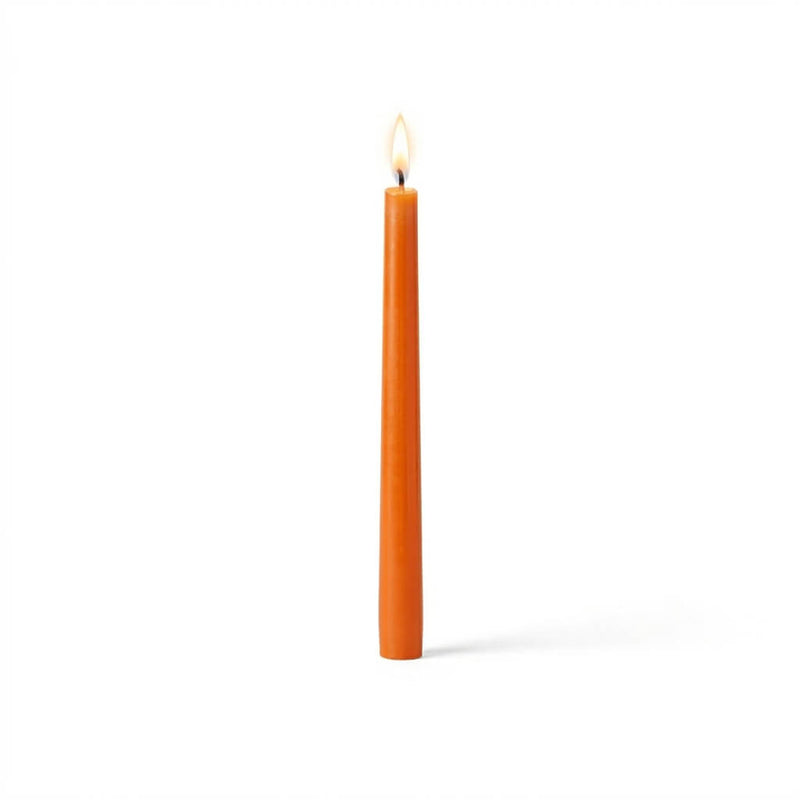 Single orange taper candle with flame on white backdrop - thumbnail number 2