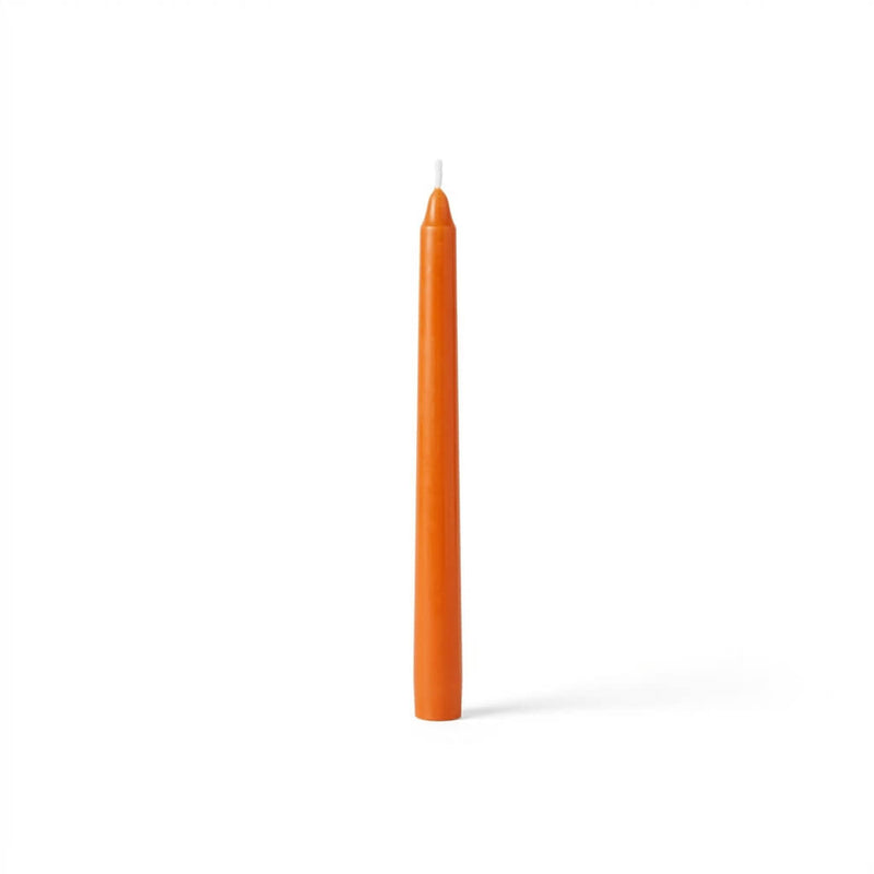 Single orange taper candle on white background - thumbnail number 1