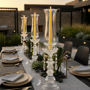 Modern outdoor dining setup with crystal candlesticks and yellow candles - thumbnail number 3