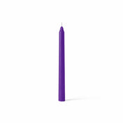 Single purple taper candle on white backdrop - thumbnail number 1