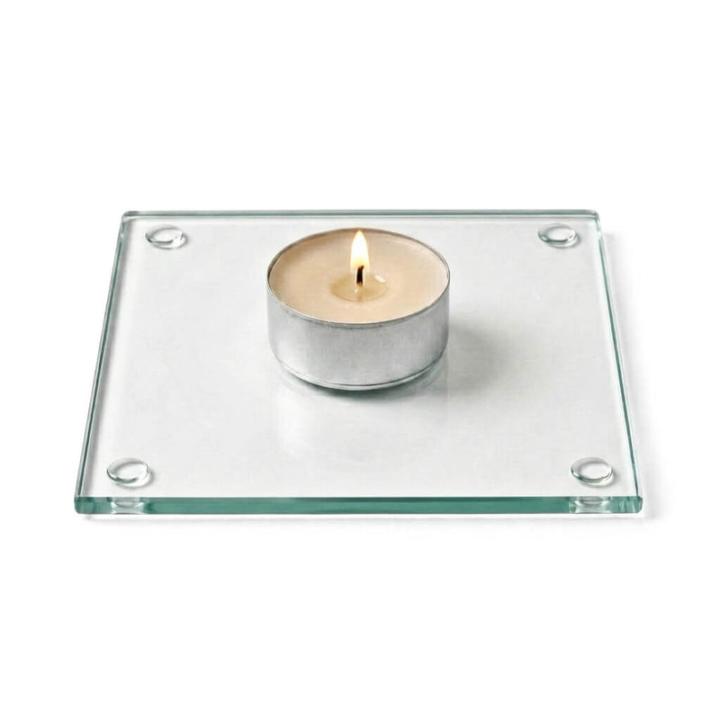 A clean product studio shot of a lit candle sitting on a clear glass Square Coaster 4" - thumbnail number 3