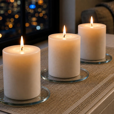Lit white pillar candles on a Round Coaster 4" display set against a city night backdrop - thumbnail number 10