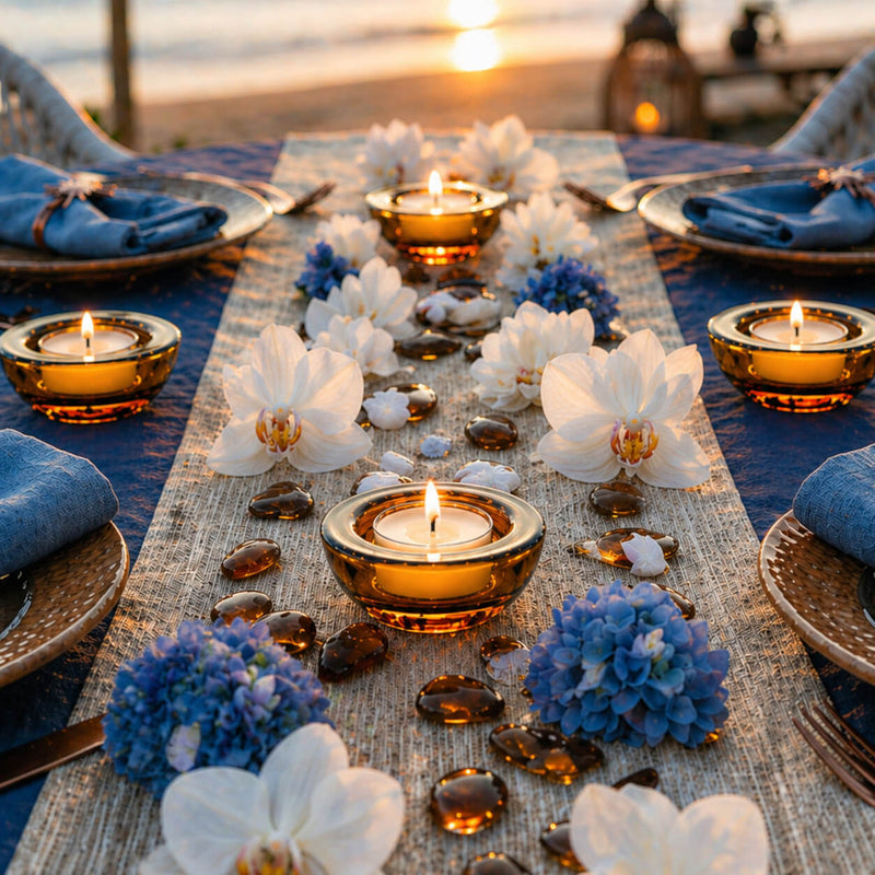 Amber glass tealights with orchids and blue hydrangeas on a beach dining table at sunset - thumbnail number 5