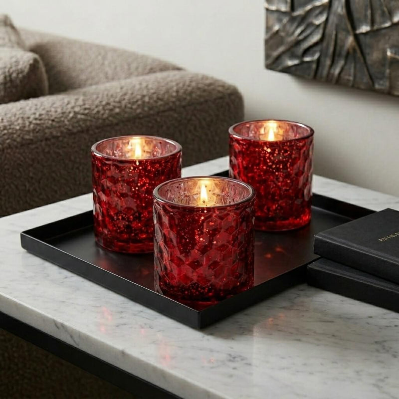 Three red honeycomb votive holders with candles on black tray in cozy living room - thumbnail number 6