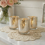 Set of glowing mercury glass candle holders on a lace mat with soft floral decor - thumbnail number 6