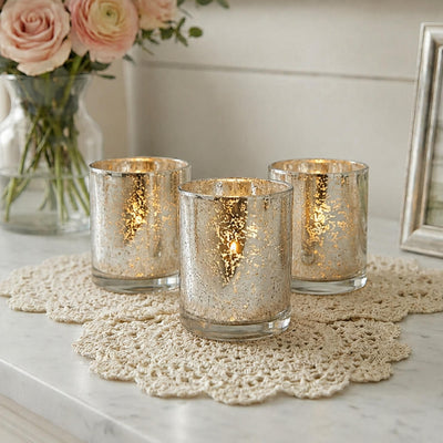 Set of glowing mercury glass candle holders on a lace mat with soft floral decor - thumbnail number 6