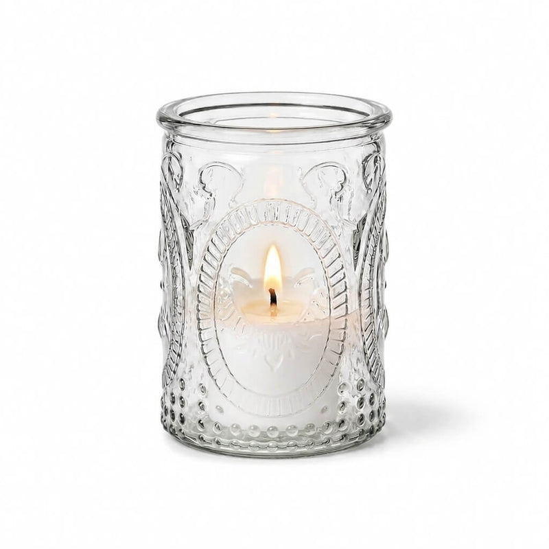 Textured clear glass candle holder with a lit white candle inside - thumbnail number 3