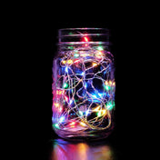 Multicolor LED fairy string lights in glass jar on black background - thumbnail number 1