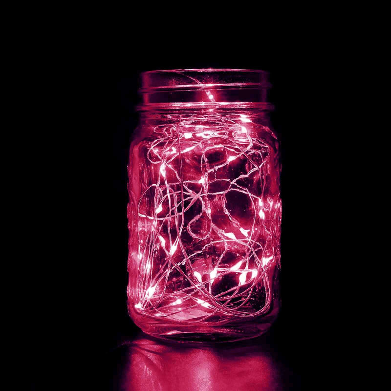 Pink fairy lights in a jar against a black background. - thumbnail number 1