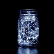 LED fairy lights in a glass jar against a dark background. - thumbnail number 1