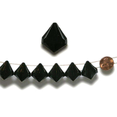 Black crystal pyramid beads on a string with a penny for scale. - thumbnail number 1