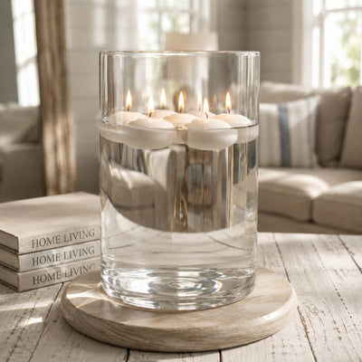 Floating white candles lit inside a large glass cylinder vase filled with water - thumbnail number 8