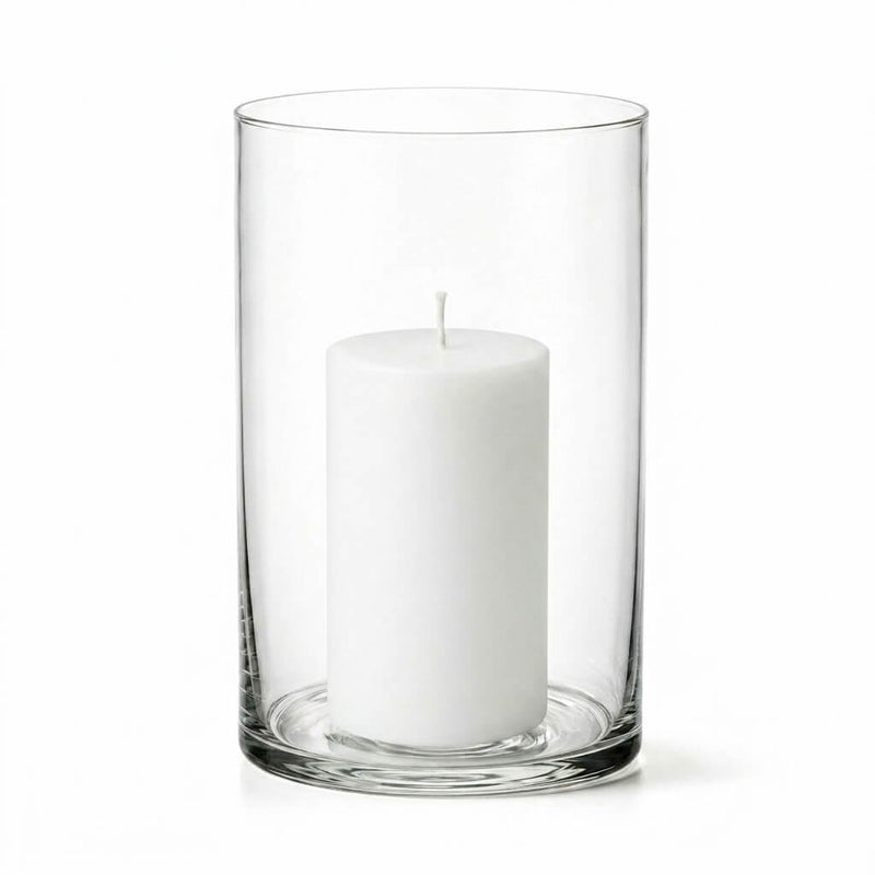 An unlit white pillar candle inside a clear glass cylinder vase on a white background - thumbnail number 2
