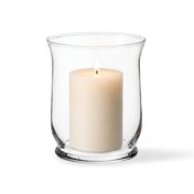 Warm candle flame glowing from within a classic clear glass 6" Hurricane Vase on white - thumbnail number 3