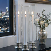 Three Glass Chimney Candle Shade 2.5" x 12" tubes over lit taper candles on a tabletop display - thumbnail number 8