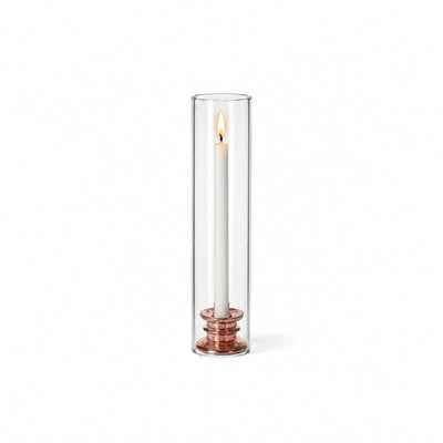 Glass Chimney Candle Shade 2.5" x 12" open tube over a lit taper candle on a solid white backdrop - thumbnail number 3