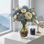 Blue and white flower bouquet in vase with pine cones - thumbnail number 5