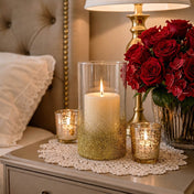 Glass candle holders adorned with gold glitter on a nightstand with red roses - thumbnail number 10