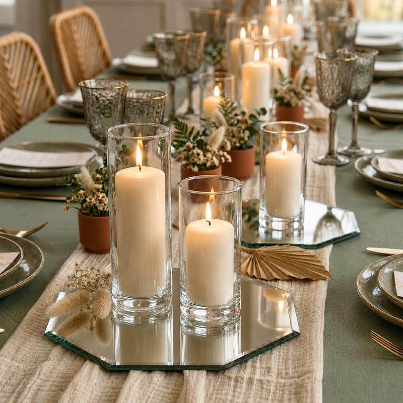 Lit pillar candles on an octagonal table mirror centerpiece with vases of dried flowers - thumbnail number 4