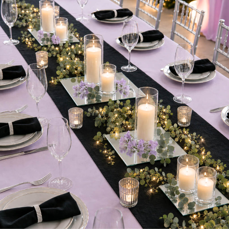 Candles on mirrored coasters with greenery and lights on a black runner for a table setting - thumbnail number 5