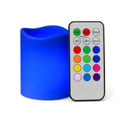 Small royal blue flameless pillar candle beside remote control - thumbnail number 4