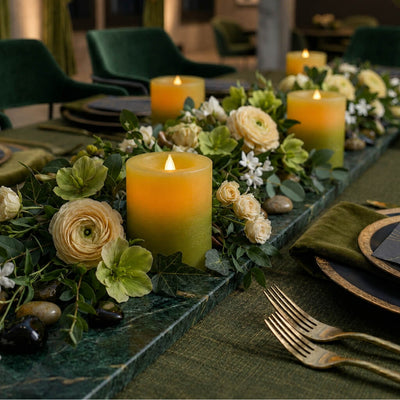 Decorative table setting with candles, flowers, and cutlery on a green tablecloth. - thumbnail number 5